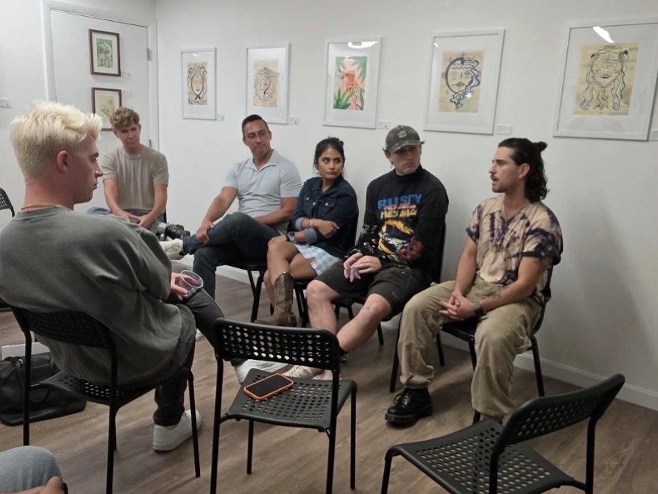 Young adults talking together in a group circle